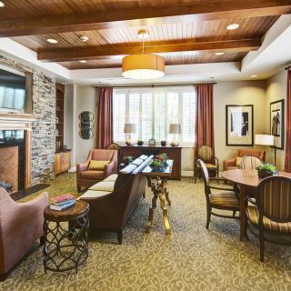 A cozy and modern living room featuring a fireplace, comfortable seating, and elegant decor.