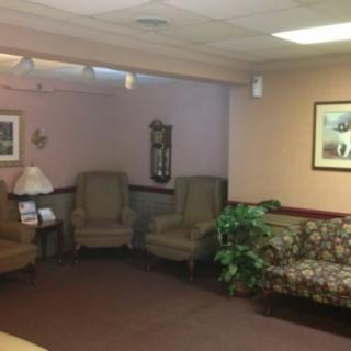 A cozy waiting room with chairs, a sofa, and a plant.