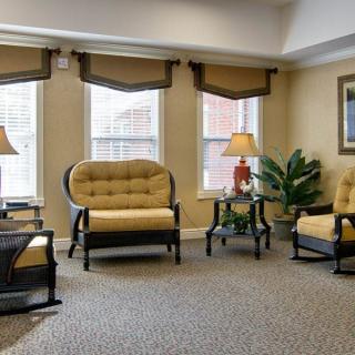 A cozy and elegantly decorated living room with comfortable seating and ambient lighting.