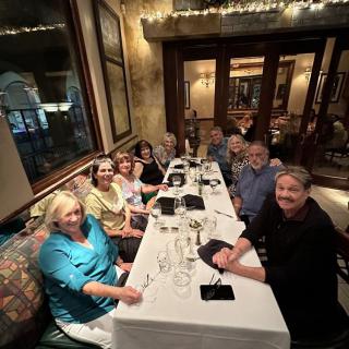 A group of people enjoying a dinner gathering at a restaurant.
