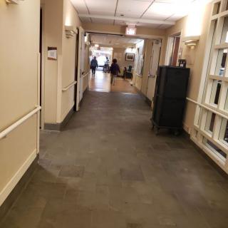 A long corridor inside a building with institutional design.