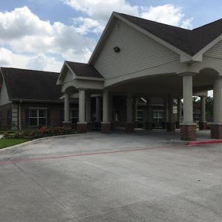 A beautiful residential building featuring an inviting entrance and landscaped surroundings.