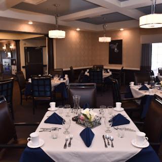 An elegant restaurant interior featuring beautifully set tables ready for guests.
