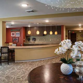 Modern reception area with elegant lighting and floral decor.