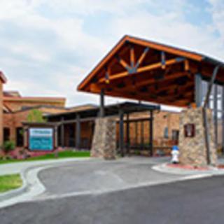 A modern building entrance with wooden and stone architectural elements.