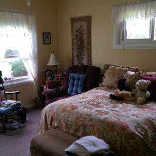 A cozy and inviting bedroom filled with soft furnishings and natural light.