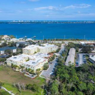 Aerial view of a coastal residential area with buildings near the water.