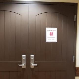 Double doors with a notice sign attached.