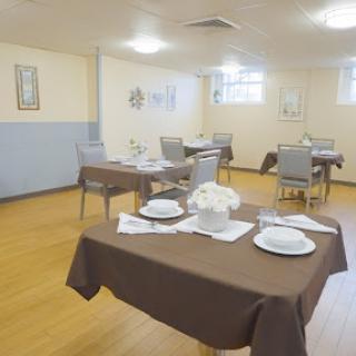 A well-set dining area with neatly arranged tables and decorative elements, ready for guests.