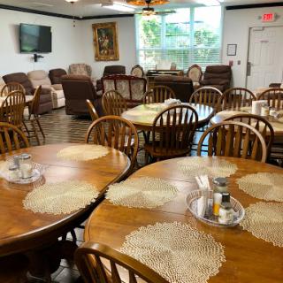A cozy dining area with wooden tables and comfortable seating, perfect for gatherings.