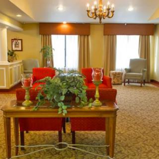 A cozy living room with warm colors, featuring comfortable seating and elegant decor.