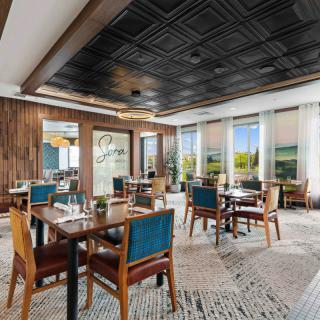 A modern dining area with elegant interior design and ample natural light.