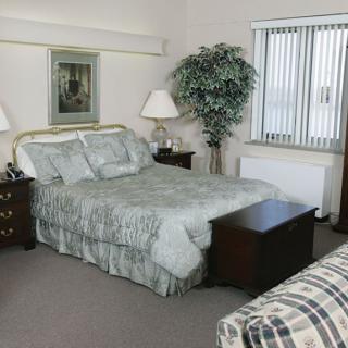 A cozy bedroom with a neatly made bed and stylish decor.