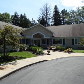A suburban house with a landscaped front yard and driveway.