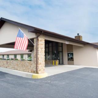 A commercial building with an American flag at the entrance.