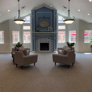 A cozy living room featuring a fireplace and elegant armchairs.
