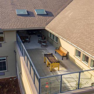 Aerial view of a house balcony with outdoor furniture and a foosball table.
