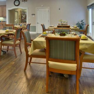 An elegantly set dining room with neatly arranged tables and chairs.