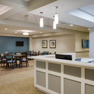 A modern reception area with seating and contemporary lighting.
