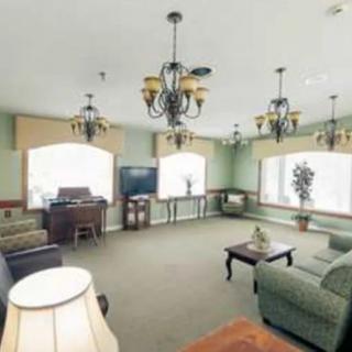 A cozy living room with elegant chandeliers and large windows.