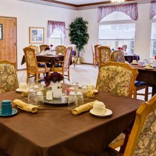 Elegantly set dining area with ornate chairs and tables.