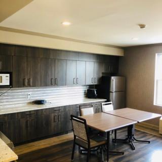 A modern kitchen and dining area with sleek cabinets and contemporary furniture.