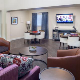 A modern living room with comfortable seating, a television, and stylish decor.