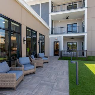 A stylish outdoor lounge area with comfortable seating and a modern architectural design.
