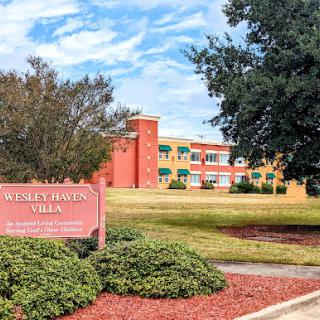 Wesley B. Jones Villa, a community residential building set against a beautiful sky.