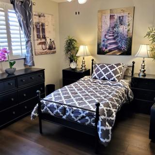 A modern bedroom with a single bed, elegant decor, and stylish furniture.