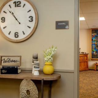 A welcoming office space featuring a large wall clock and decorative elements.