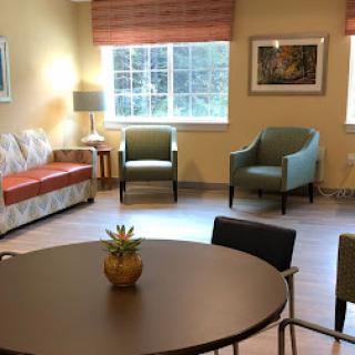 A cozy, well-lit living room featuring comfortable seating and a contemporary design.