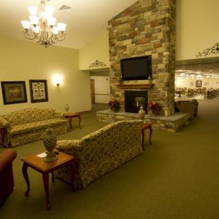 A cozy living room with a stone fireplace and elegant furniture.