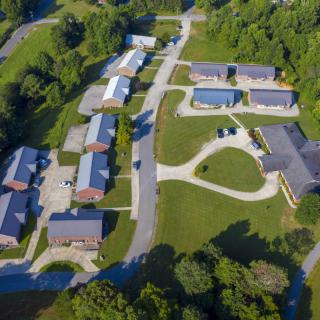 An aerial view of a residential neighborhood surrounded by greenery.
