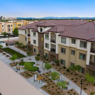 A modern apartment complex with well-maintained landscaping.