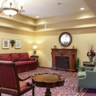 A cozy living room with a fireplace, sofas, and elegant decor.
