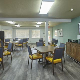 An empty dining area with tables and chairs arranged neatly.