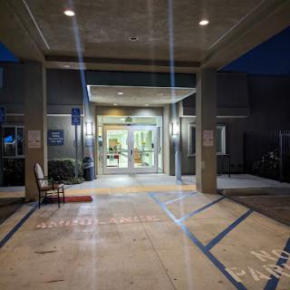 The illuminated entrance of a building at night, showcasing a welcoming atmosphere.