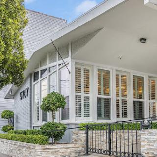 A modern residential home featuring elegant architecture and well-kept landscaping.