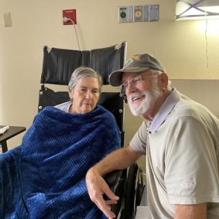 A comforting moment shared between a patient and their companion in a hospital setting.