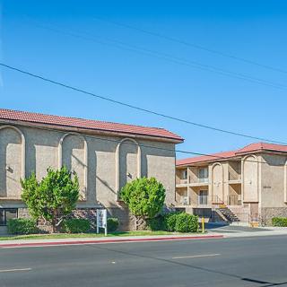 An apartment building with a clear blue sky in the background.