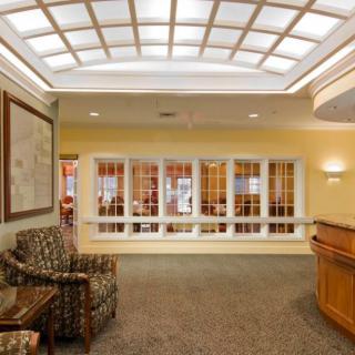 A well-lit lobby with comfortable seating and a reception desk.