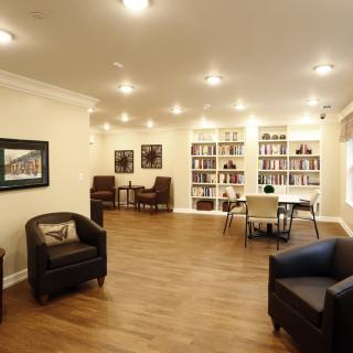 A cozy living room with comfortable seating and bookshelves.