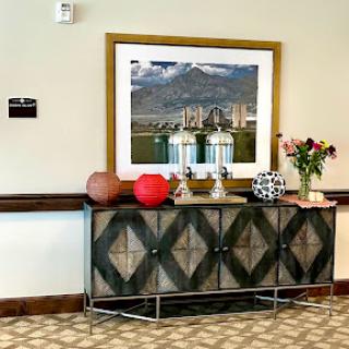 An elegantly styled console table with decorative items and a framed photograph, enhancing the interior space.