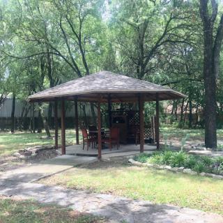 A charming gazebo surrounded by greenery, perfect for enjoying nature.