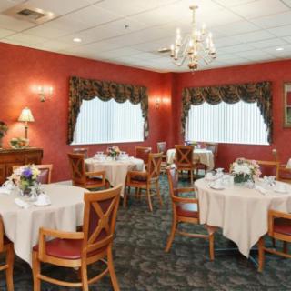 A cozy restaurant dining area with elegantly set tables and a warm ambiance.