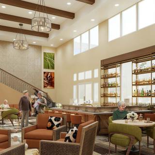 A modern lounge area with comfortable seating and a bar, featuring large windows and stylish lighting.