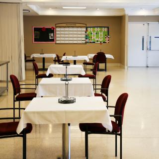 A serene dining area featuring neatly arranged tables and chairs, ready for guests.