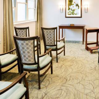A well-arranged conference room with elegant chairs and a patterned carpet.