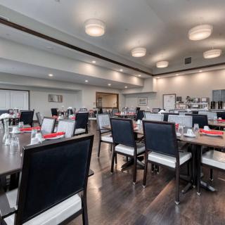 A modern restaurant dining area with neatly arranged tables and chairs.